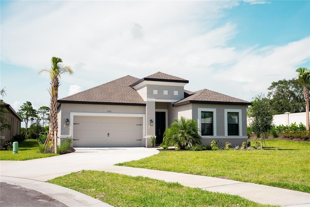 5684 Blue Reef Pl, Nokomis, FL 34275 - prairie-style house with a front yard, roof with shingles, stucco siding, an attached garage, and driveway