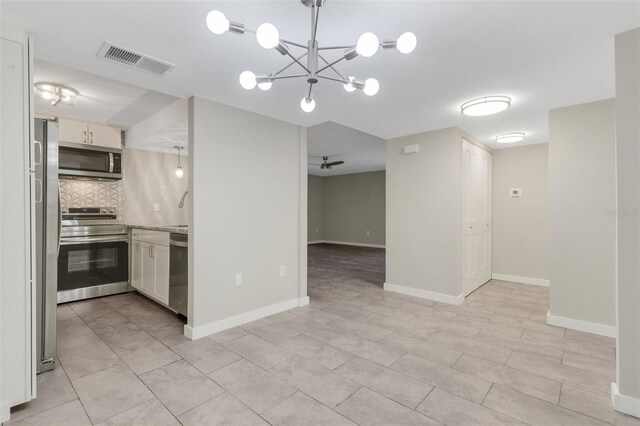 2319 Beneva Ter Unit 2284, Sarasota, FL 34232 - kitchen with backsplash, stainless steel appliances, white cabinets, and visible vents