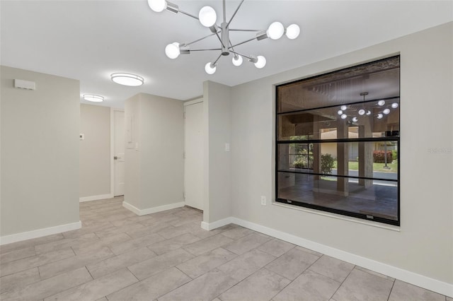 2319 Beneva Ter Unit 2284, Sarasota, FL 34232 - spare room featuring baseboards and an inviting chandelier