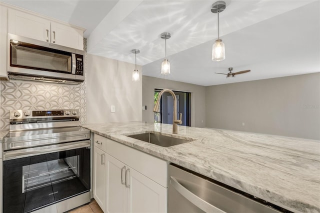 2319 Beneva Ter Unit 2284, Sarasota, FL 34232 - kitchen with decorative light fixtures, tasteful backsplash, light stone countertops, a sink, and stainless steel appliances