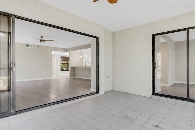 2319 Beneva Ter Unit 2284, Sarasota, FL 34232 - interior space featuring visible vents, a sink, a textured wall, tile patterned floors, and a ceiling fan