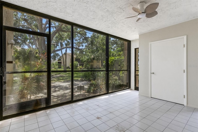 2319 Beneva Ter Unit 2284, Sarasota, FL 34232 - unfurnished sunroom featuring a ceiling fan, a textured ceiling, expansive windows, and tile patterned floors