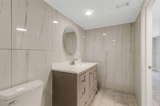 2319 Beneva Ter Unit 2284, Sarasota, FL 34232 - half bathroom featuring tile walls, vanity, toilet, and visible vents