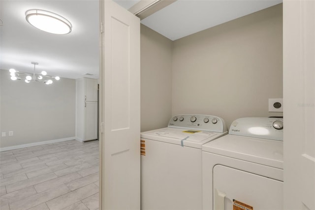 2319 Beneva Ter Unit 2284, Sarasota, FL 34232 - washroom featuring washing machine and clothes dryer, laundry area, and baseboards