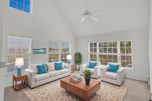 carpeted living room with baseboards, high vaulted ceiling, and ceiling fan