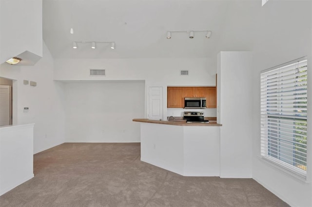 kitchen featuring visible vents, appliances with stainless steel finishes, track lighting, and carpet