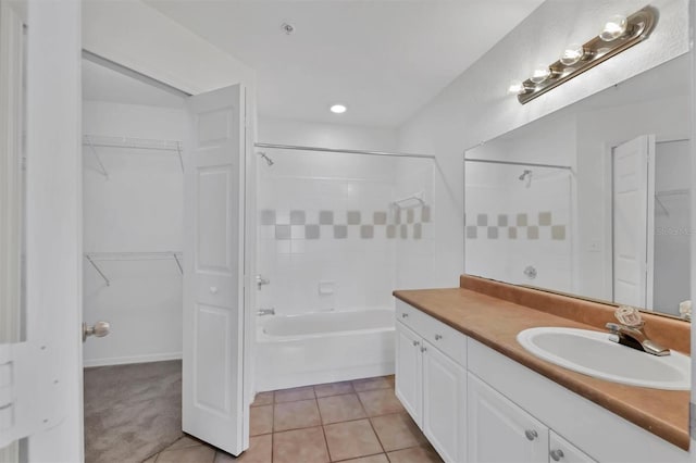 full bath with vanity, tile patterned flooring, shower / tub combination, and a spacious closet
