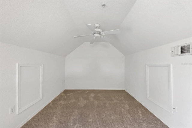 additional living space with visible vents, carpet floors, baseboards, a ceiling fan, and vaulted ceiling