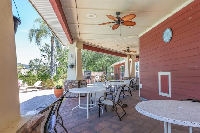 view of patio featuring ceiling fan, fence, and outdoor dining area