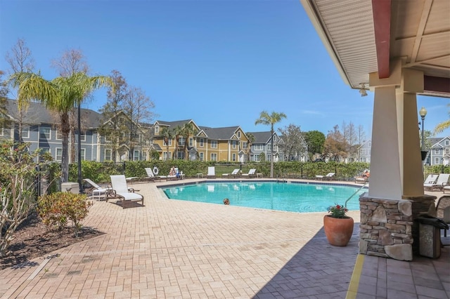 pool with a patio and a residential view