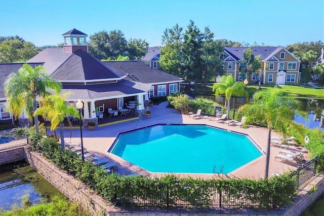 pool with fence and a patio area