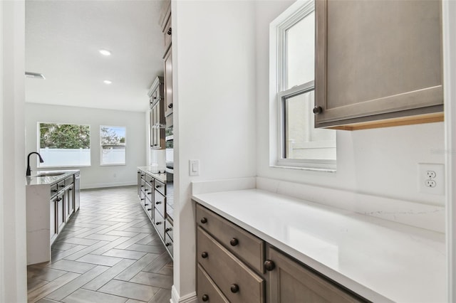 3113 W Nassau St, Tampa, FL 33607 - kitchen with a sink, light countertops, baseboards, and recessed lighting