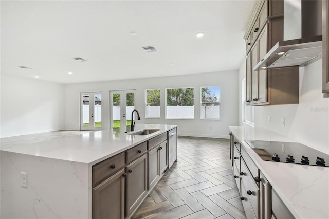 3113 W Nassau St, Tampa, FL 33607 - kitchen with a sink, wall chimney exhaust hood, black electric stovetop, stainless steel dishwasher, and recessed lighting