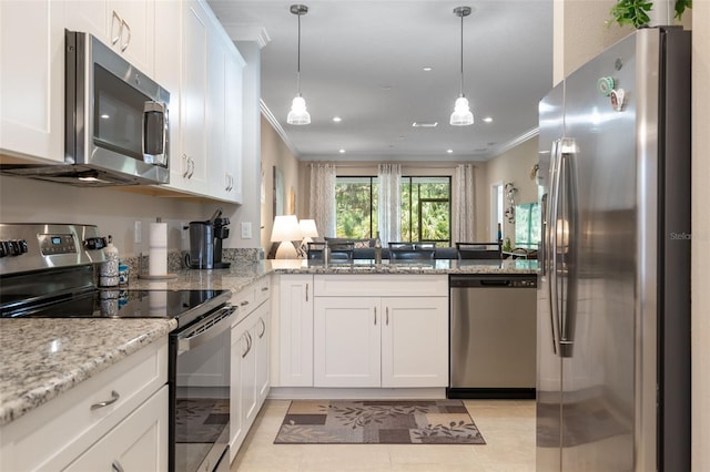 kitchen featuring crown molding, white cabinets, and appliances with stainless steel finishes