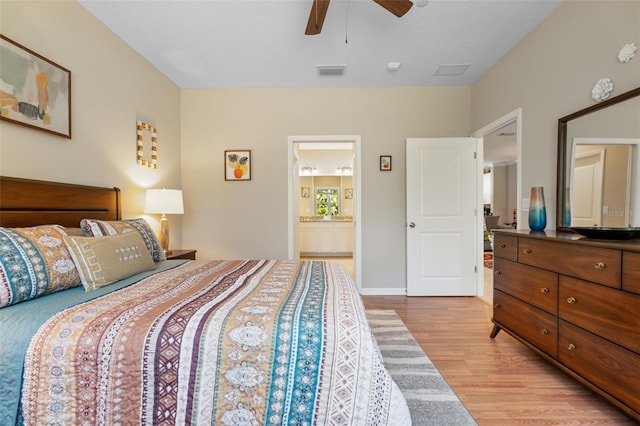 bedroom featuring visible vents, baseboards, ceiling fan, connected bathroom, and light wood finished floors