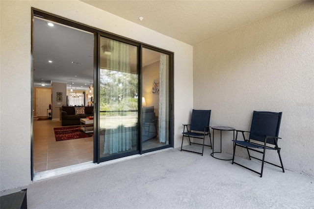 doorway to property featuring stucco siding