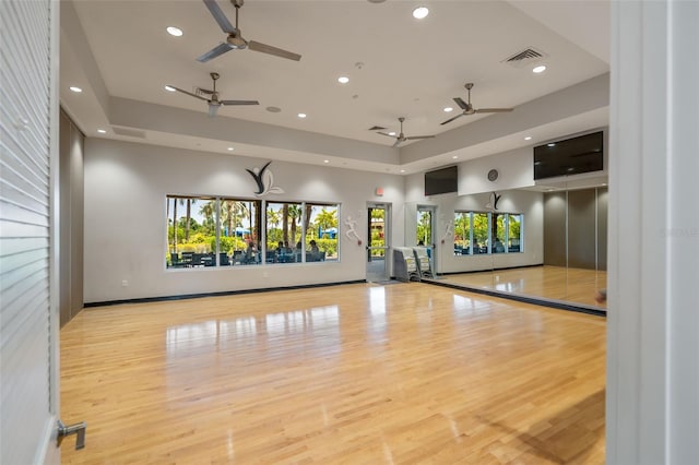 exercise room featuring ceiling fan, recessed lighting, wood finished floors, and visible vents