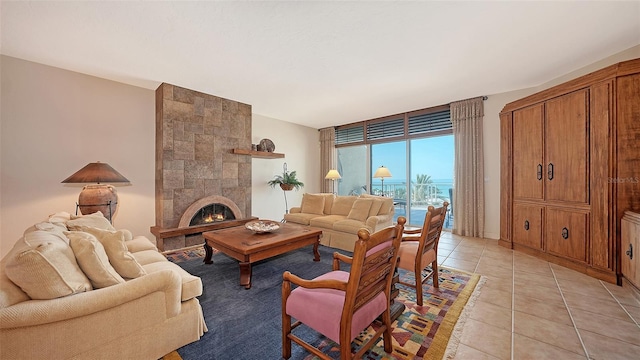 2185 Gulf Of Mexico Dr Unit 243, Longboat Key, FL 34228 - living area featuring light tile patterned floors and a tile fireplace