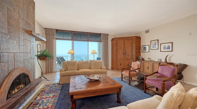 2185 Gulf Of Mexico Dr Unit 243, Longboat Key, FL 34228 - living room with light tile patterned floors and a fireplace