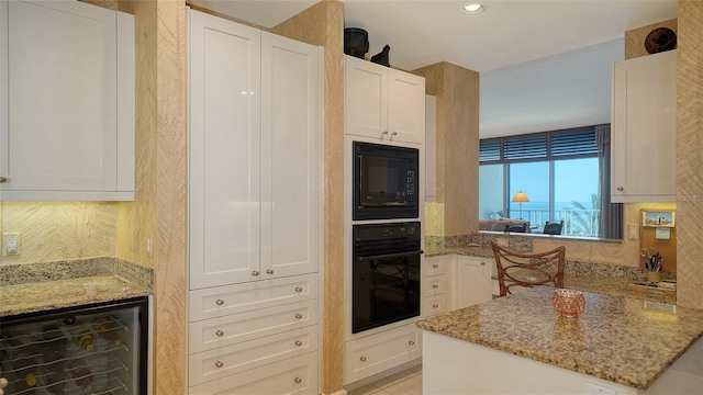 2185 Gulf Of Mexico Dr Unit 243, Longboat Key, FL 34228 - kitchen with black appliances, beverage cooler, white cabinets, backsplash, and recessed lighting