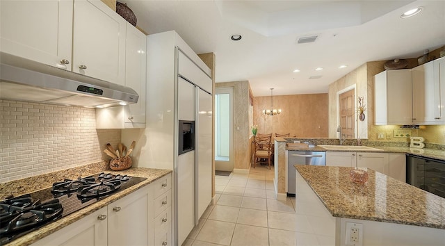 2185 Gulf Of Mexico Dr Unit 243, Longboat Key, FL 34228 - kitchen with dishwasher, black gas stovetop, under cabinet range hood, a sink, and light tile patterned floors