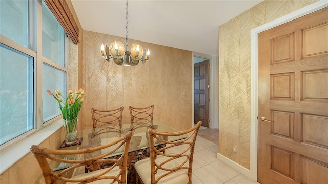 2185 Gulf Of Mexico Dr Unit 243, Longboat Key, FL 34228 - dining room featuring a chandelier, light tile patterned floors, and wallpapered walls