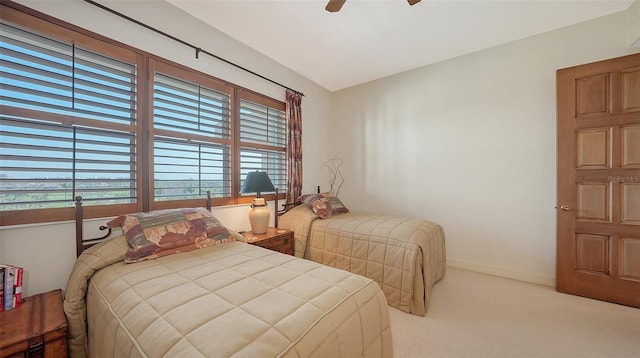 2185 Gulf Of Mexico Dr Unit 243, Longboat Key, FL 34228 - bedroom with light carpet, multiple windows, baseboards, and ceiling fan