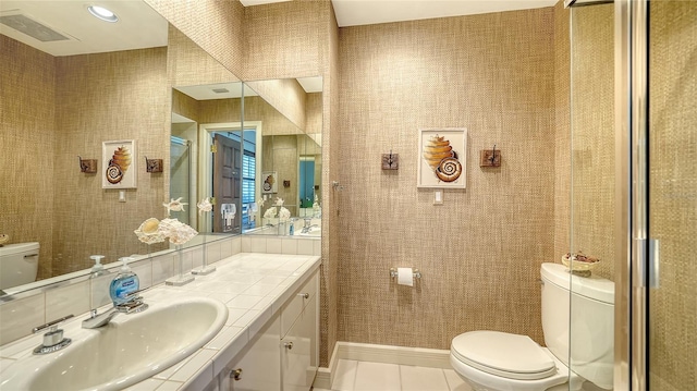 2185 Gulf Of Mexico Dr Unit 243, Longboat Key, FL 34228 - full bathroom with toilet, vanity, tile patterned flooring, and a stall shower