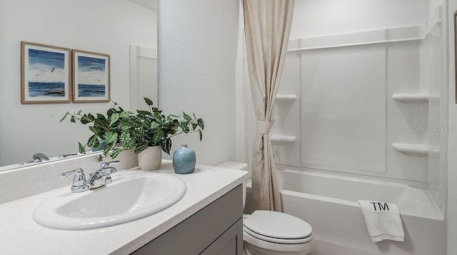 bathroom featuring vanity, shower / bath combo with shower curtain, and toilet