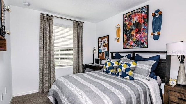 bedroom featuring baseboards and carpet