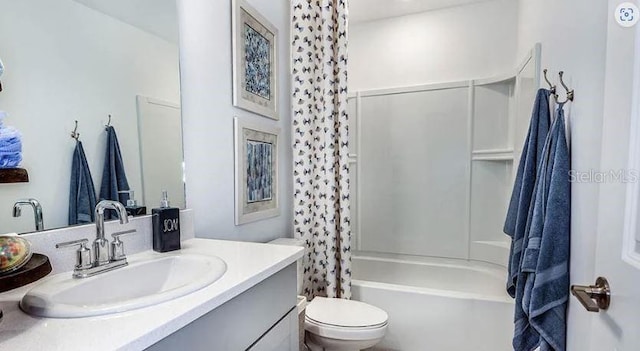 bathroom with vanity, shower / bathtub combination with curtain, and toilet