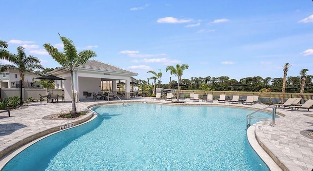 pool with fence and a patio