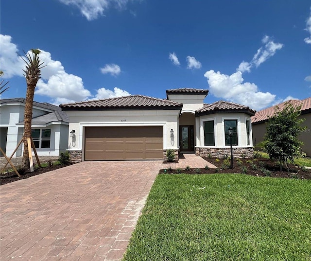 6203 Grandview Hill Ct, Bradenton, FL 34203 - mediterranean / spanish-style house featuring stone siding, stucco siding, decorative driveway, a garage, and a tile roof