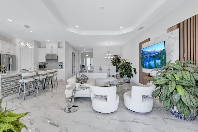 6203 Grandview Hill Ct, Bradenton, FL 34203 - living room featuring recessed lighting, a chandelier, light marble finish floors, and a tray ceiling