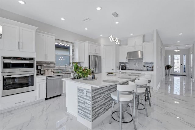 6203 Grandview Hill Ct, Bradenton, FL 34203 - kitchen with stainless steel appliances, light marble finish floors, decorative backsplash, and recessed lighting