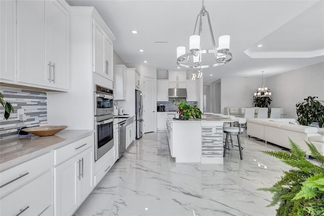 6203 Grandview Hill Ct, Bradenton, FL 34203 - kitchen featuring a chandelier, under cabinet range hood, appliances with stainless steel finishes, recessed lighting, and tasteful backsplash