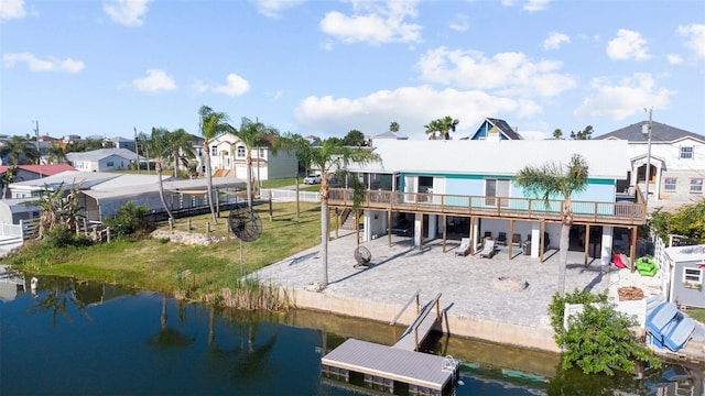 back of property with a residential view and a deck with water view