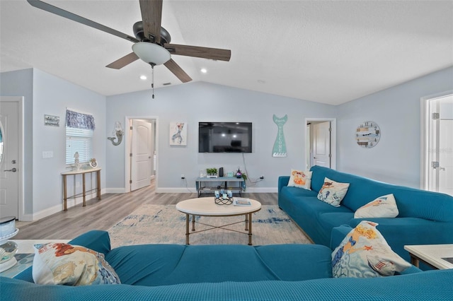 living area featuring a ceiling fan, baseboards, recessed lighting, wood finished floors, and vaulted ceiling