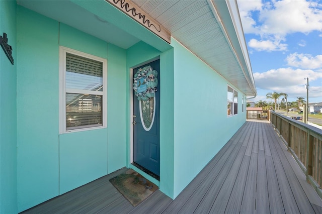 doorway to property featuring a balcony and stucco siding