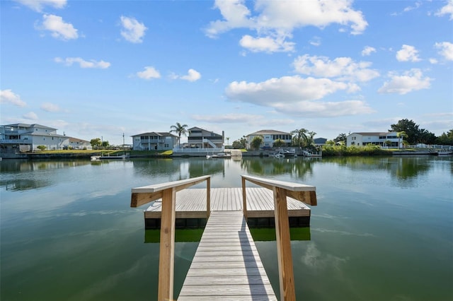 dock area with a residential view and a water view