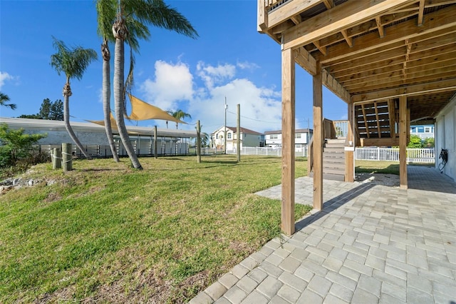 view of yard featuring fence, stairs, and a patio