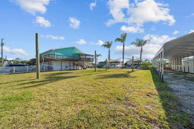 view of yard with fence and a detached carport