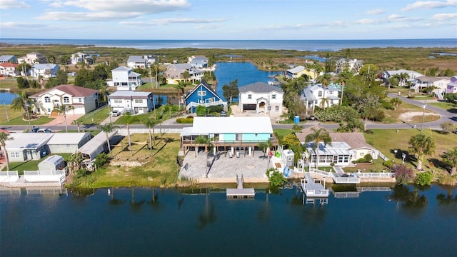 drone / aerial view featuring a residential view and a water view