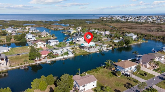 drone / aerial view with a water view and a residential view