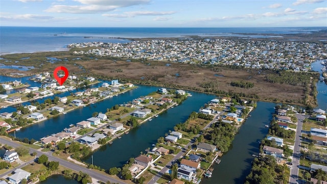 drone / aerial view featuring a residential view and a water view