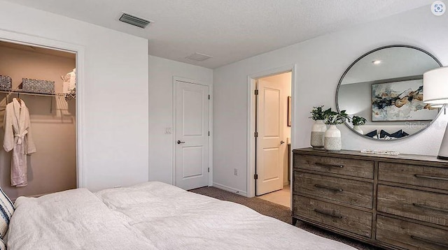 bedroom with baseboards, light colored carpet, and visible vents