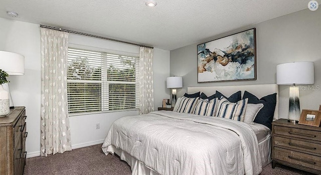 carpeted bedroom featuring baseboards and a textured ceiling