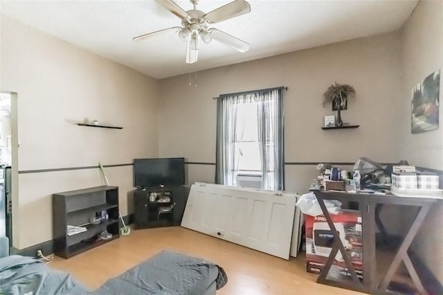 interior space with a ceiling fan and wood finished floors