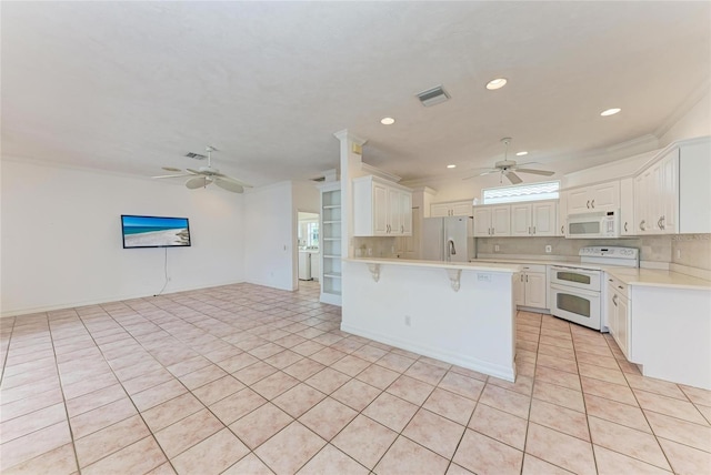 585 Khyber Ln, Venice, FL 34293 - kitchen featuring white appliances, ceiling fan, a peninsula, light countertops, and recessed lighting