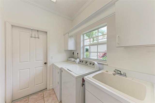 585 Khyber Ln, Venice, FL 34293 - washroom featuring washer and dryer, cabinet space, crown molding, and light tile patterned floors